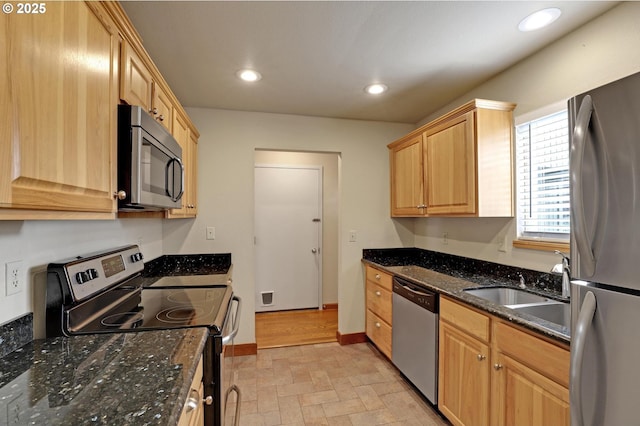 kitchen featuring visible vents, recessed lighting, dark stone countertops, appliances with stainless steel finishes, and a sink