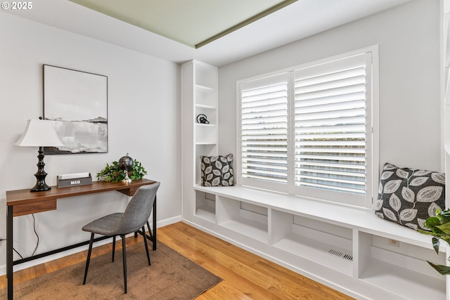 home office with hardwood / wood-style flooring