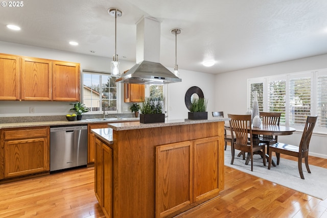 kitchen with dishwasher, hanging light fixtures, island range hood, a kitchen island, and light wood-type flooring