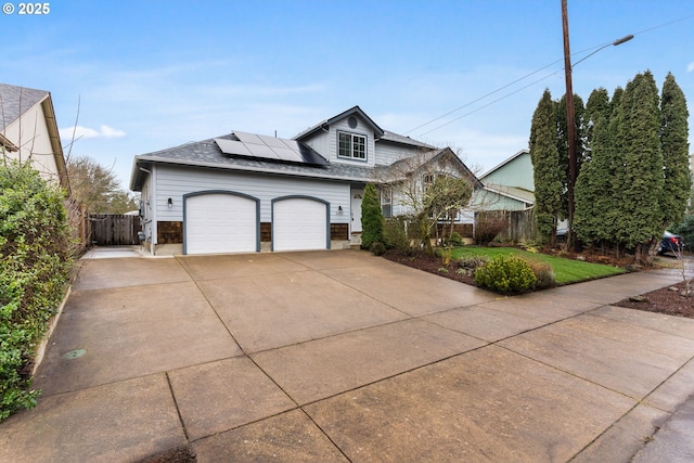 view of front property with a garage and solar panels