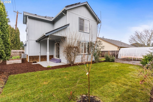 back of property featuring a yard and an outbuilding