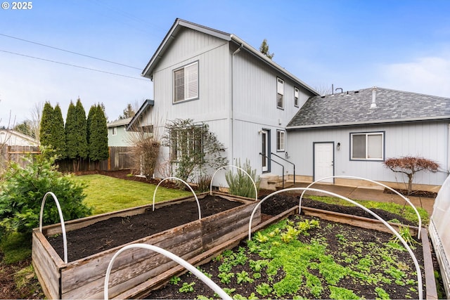 rear view of property featuring a yard