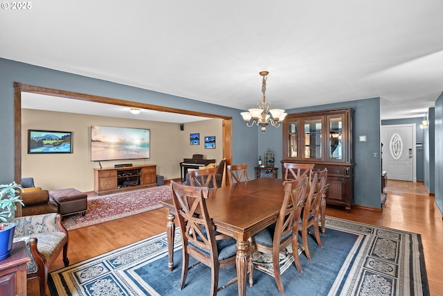dining space with a chandelier and light wood finished floors