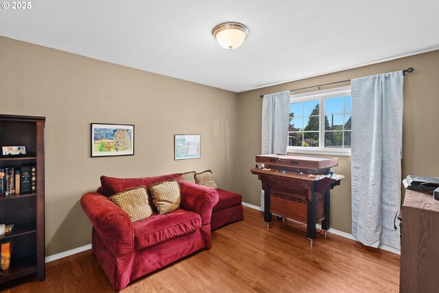 sitting room with wood finished floors and baseboards