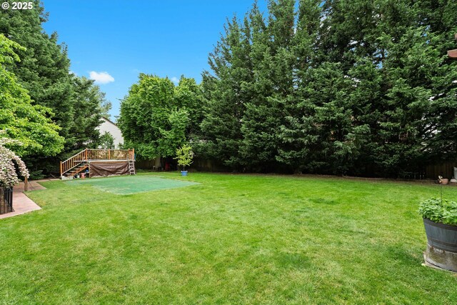 view of yard featuring a wooden deck and stairway
