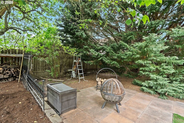 view of patio / terrace featuring a fire pit and a fenced backyard