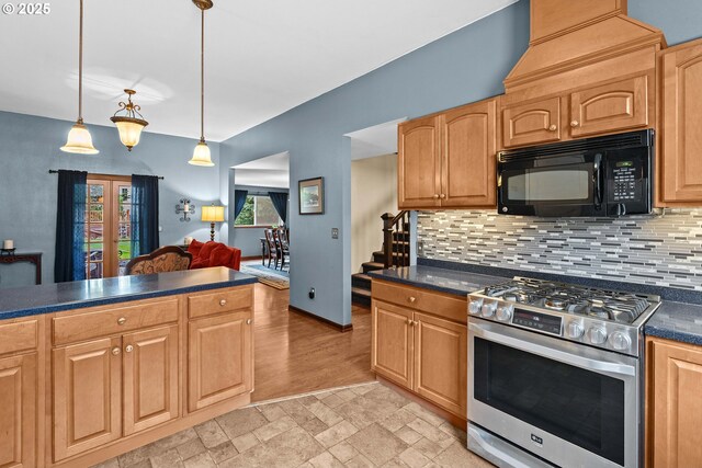 kitchen featuring stainless steel gas range oven, black microwave, dark countertops, tasteful backsplash, and pendant lighting