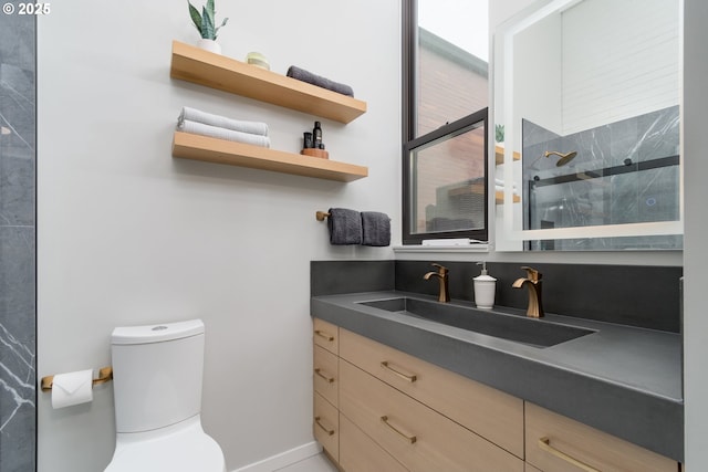 bathroom featuring vanity, toilet, and walk in shower