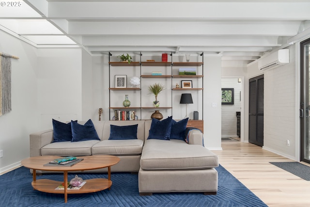 living room featuring hardwood / wood-style flooring, an AC wall unit, and beam ceiling