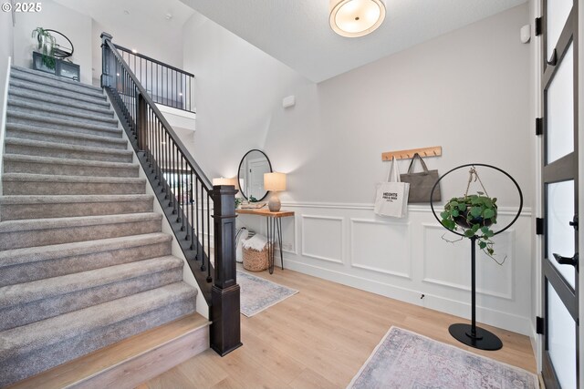 4148 S 11th Cir, Ridgefield, WA 98642 - entrance foyer with stairway, wood finished floors, a wainscoted wall, and a decorative wall