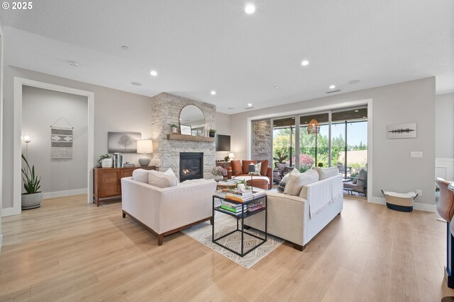 4148 S 11th Cir, Ridgefield, WA 98642 - living room with a stone fireplace, light wood-style flooring, and recessed lighting