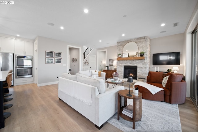 4148 S 11th Cir, Ridgefield, WA 98642 - living area featuring light wood-style floors, a fireplace, recessed lighting, and stairs
