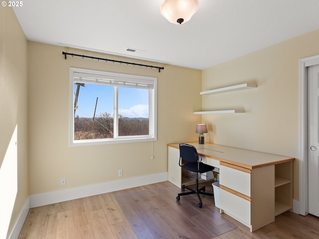 home office featuring visible vents, baseboards, and wood finished floors