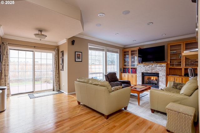 living room featuring crown molding, a wealth of natural light, and light wood-type flooring