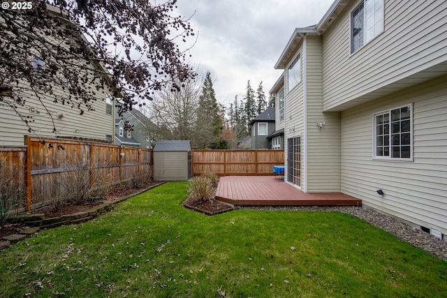 view of yard with a wooden deck and a storage shed