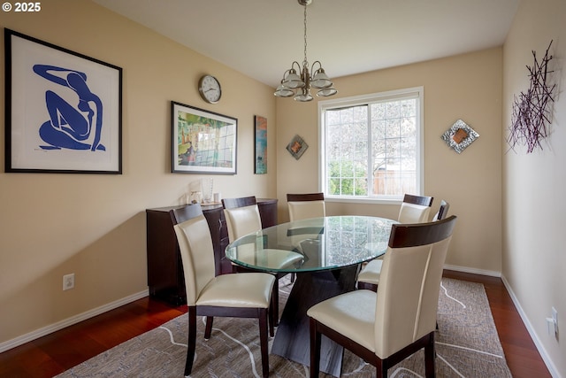 dining area with dark hardwood / wood-style floors and a chandelier