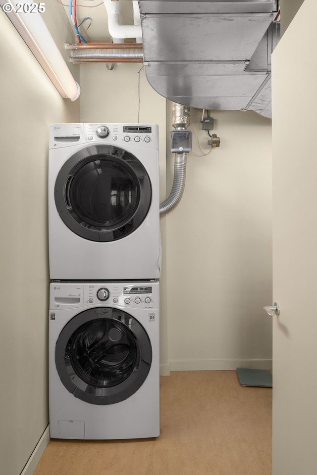 laundry room with stacked washer and clothes dryer