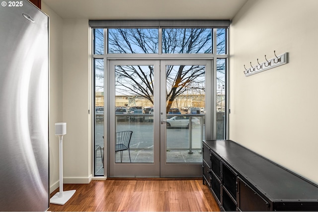 entryway with wood-type flooring and french doors