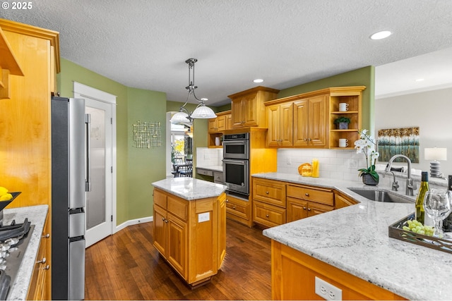 kitchen featuring dark wood finished floors, appliances with stainless steel finishes, open shelves, and a sink