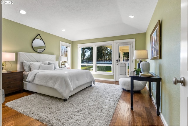 bedroom with recessed lighting, a textured ceiling, baseboards, and wood finished floors