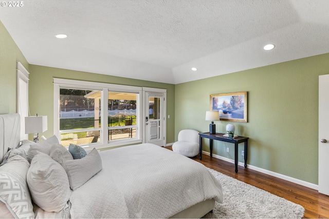 bedroom featuring access to exterior, baseboards, wood finished floors, and recessed lighting