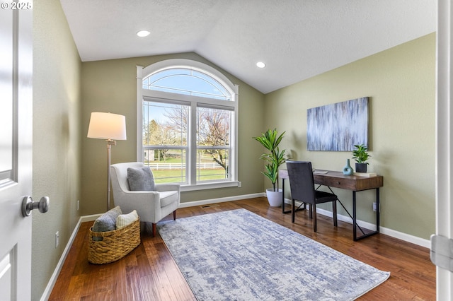 office featuring lofted ceiling, a textured ceiling, baseboards, and wood finished floors