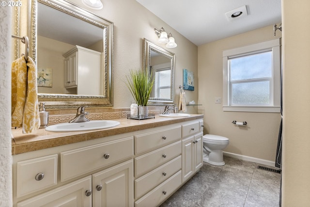 full bath with a wealth of natural light, a sink, and double vanity