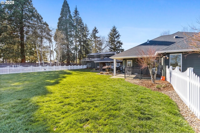 view of yard with a fenced backyard