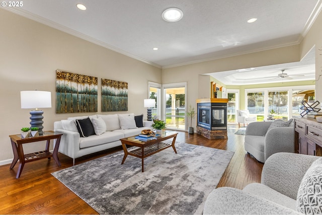 living room featuring recessed lighting, dark wood finished floors, and crown molding