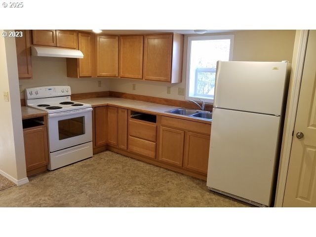 kitchen featuring sink and white appliances