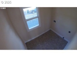 laundry area featuring hookup for an electric dryer and carpet flooring