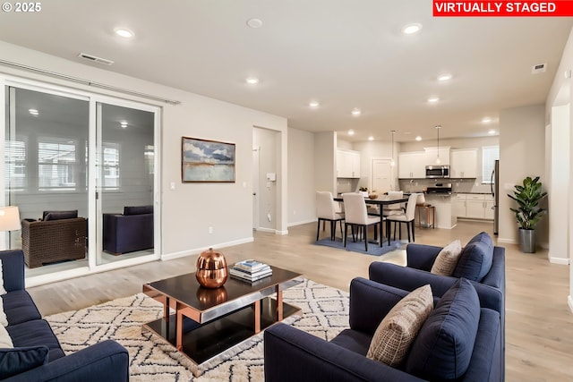 31028 NW Turel Dr, North Plains, OR 97133 - living room featuring light wood-style floors, baseboards, and recessed lighting