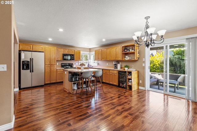 kitchen with open shelves, light countertops, a chandelier, black appliances, and dark wood-type flooring