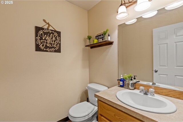 bathroom with toilet and vanity