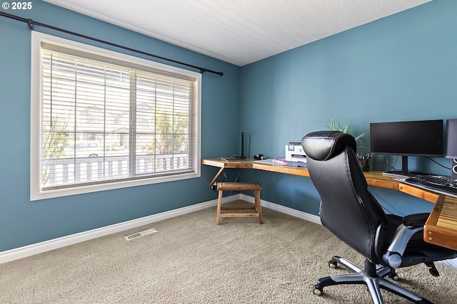 office space with visible vents, baseboards, and carpet floors