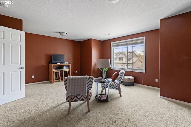 living area featuring carpet flooring, visible vents, baseboards, and a textured ceiling