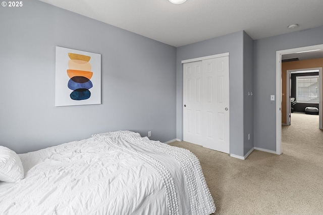 bedroom with carpet flooring, a closet, and baseboards