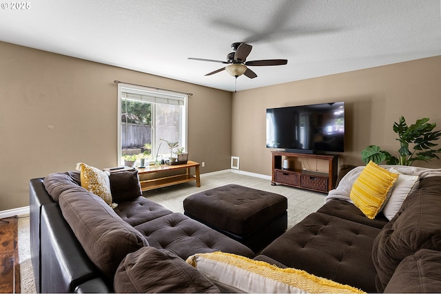 living room featuring light colored carpet, baseboards, and a ceiling fan