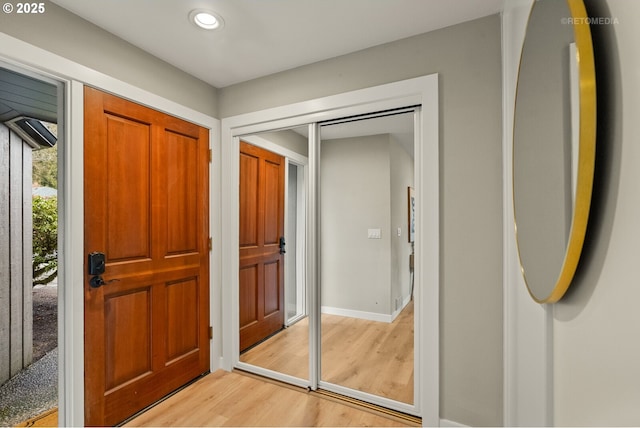 entryway featuring baseboards, light wood-style floors, and recessed lighting