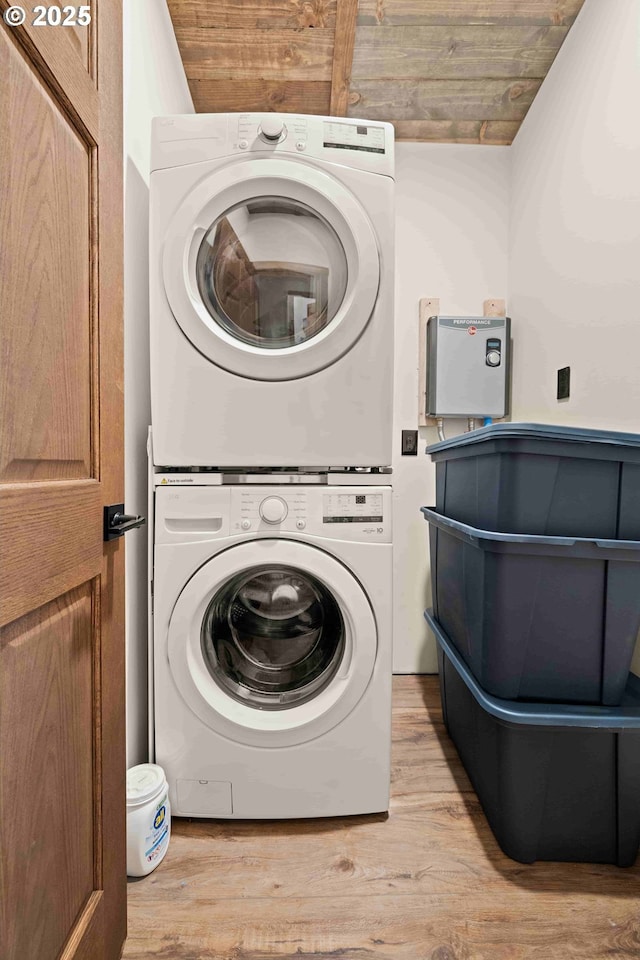82339 Maple Rd, Seaside, OR 97138 - washroom with stacked washer and clothes dryer and light wood-style floors