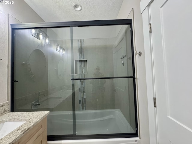 6604 NE Logan Rd, Lincoln City, OR 97367 - bathroom featuring a shower with door, vanity, and a textured ceiling