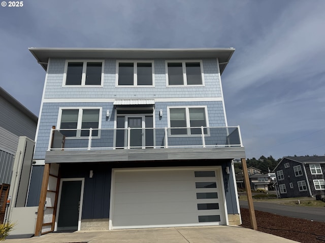 6604 NE Logan Rd, Lincoln City, OR 97367 - view of front of property featuring a balcony, driveway, and a garage