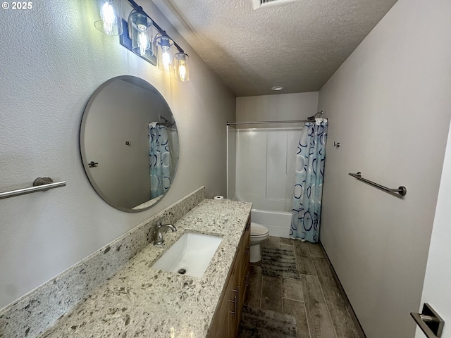 6604 NE Logan Rd, Lincoln City, OR 97367 - bathroom featuring vanity, a textured ceiling, wood finished floors, and shower / bath combo with shower curtain