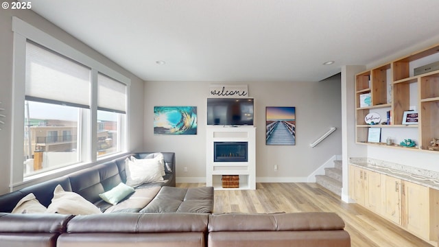 6604 NE Logan Rd, Lincoln City, OR 97367 - living area featuring light wood-type flooring, a fireplace, stairway, and recessed lighting