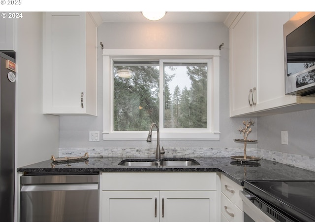 kitchen featuring sink, white cabinets, plenty of natural light, and appliances with stainless steel finishes