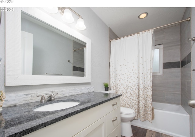 full bathroom featuring shower / bath combo with shower curtain, wood-type flooring, toilet, and vanity