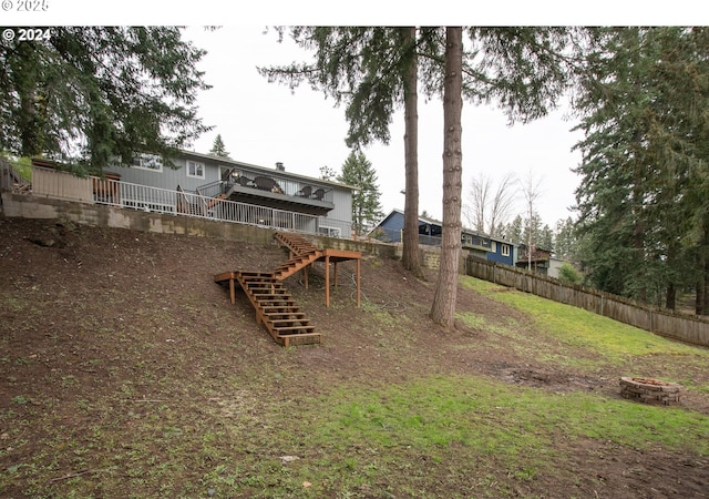 view of yard with an outdoor fire pit and a wooden deck