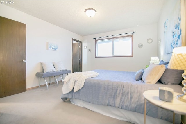 bedroom featuring carpet and baseboards