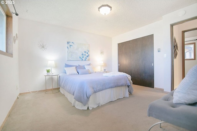 bedroom with carpet, a closet, and a textured ceiling