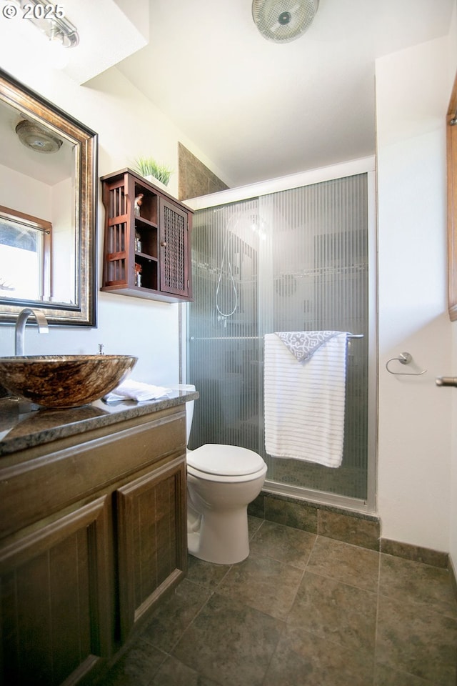 full bath with a stall shower, vanity, and toilet